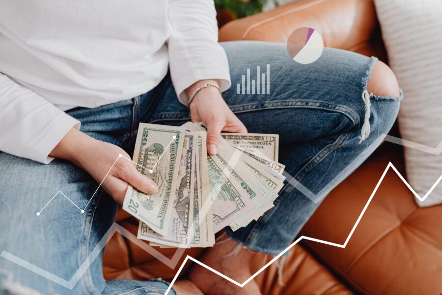 Graphs overlaying a woman holding cash