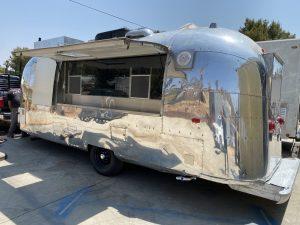 Polished exterior of Ojai Valley Inn catering trailer with open serving door