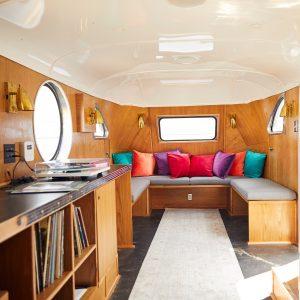 Interior of Snapchat's custom vintage trailer lounge with banquette seating
