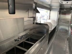 Interior of Happy Anchor food truck with sink and serving window