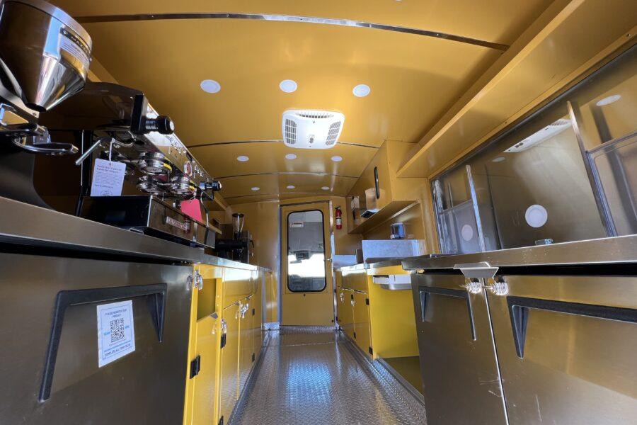 Custom powder coated yellow interior walls, ceiling and cabinet of Little Lamb ice cream truck