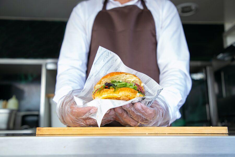 Food truck chef holding a gourmet burger