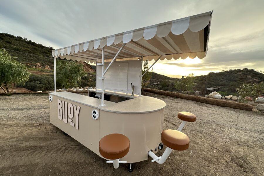 Buoy customized marketing trailer with awning and barstools