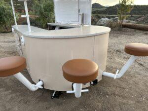 Three barstools with camel colored vinyl upholstered seats on Buoy experiential marketing vehicle