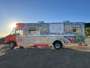 Exterior of the driver's side Semihandmade marketing vehicle wrap at sunset