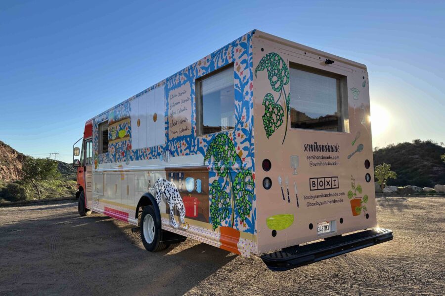 Exterior of the rear driver's side Semihandmade marketing vehicle wrap at sunset